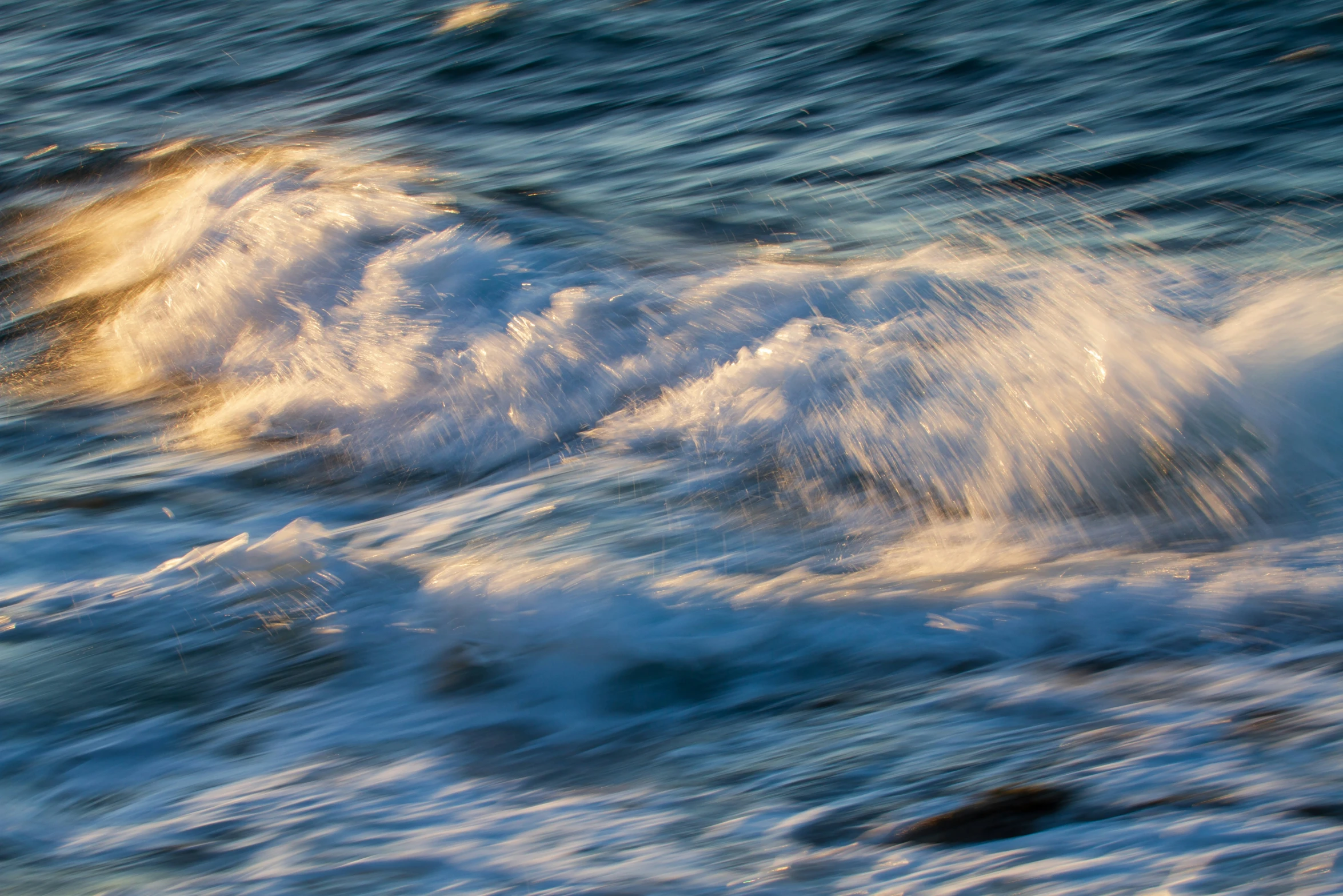 some white foam on the water and waves