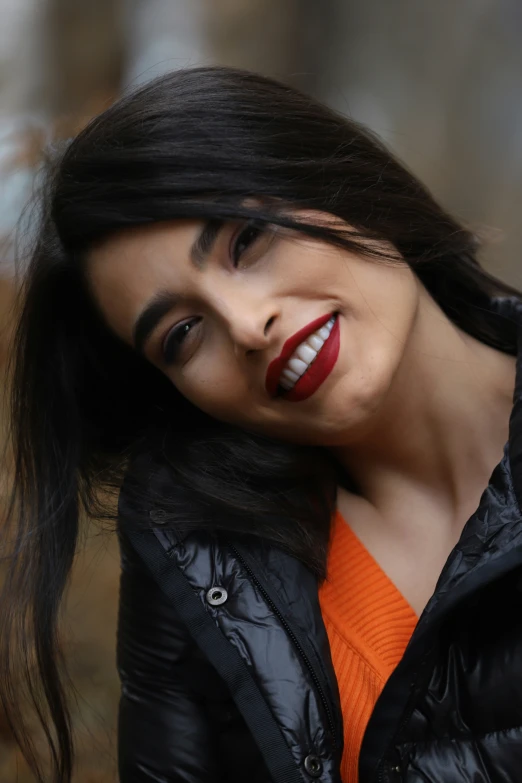 a beautiful young woman wearing red lipstick with a smile