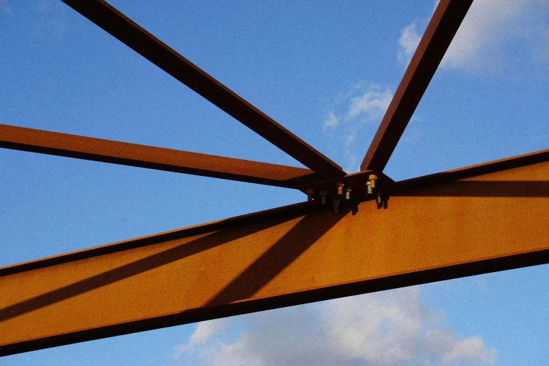 a view from underneath a yellow umbrella against the blue sky