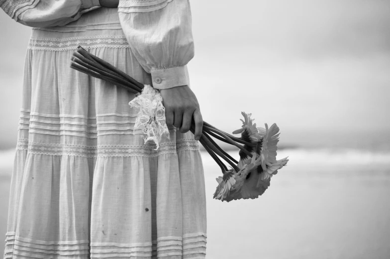 the woman is holding the flowers in her hands