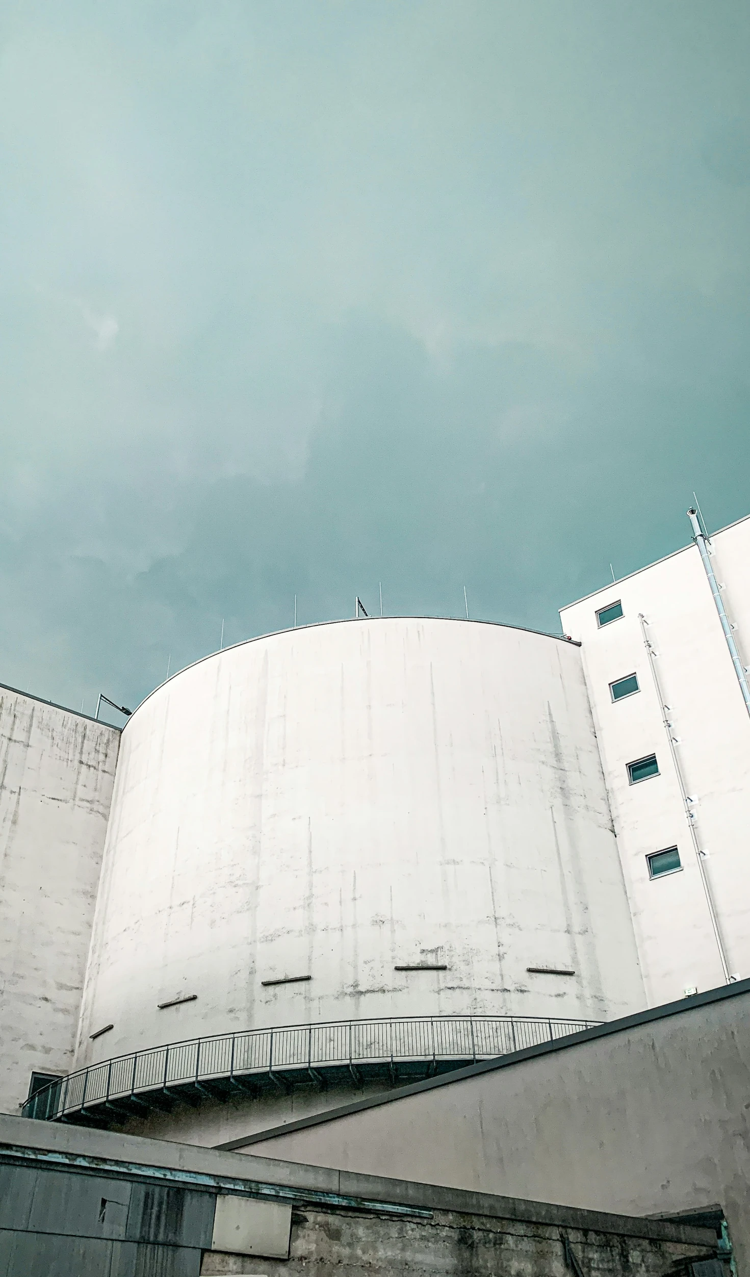 a large building with white walls and pillars on top of it