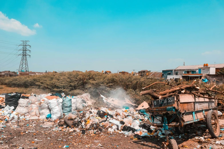 the pile of garbage in front of a house and power lines