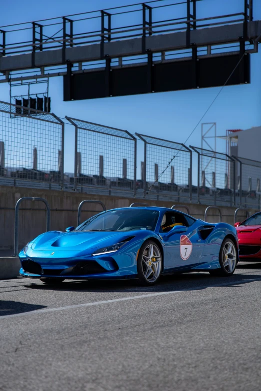 the two vehicles are racing down the track