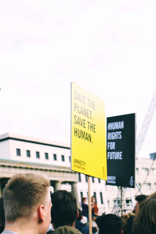 a group of people gathered around holding signs