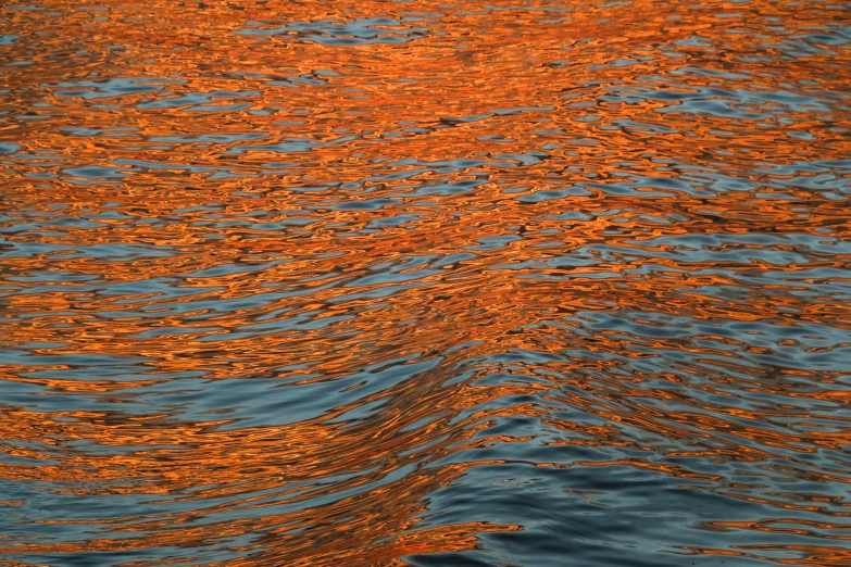 a view of a body of water with orange hues