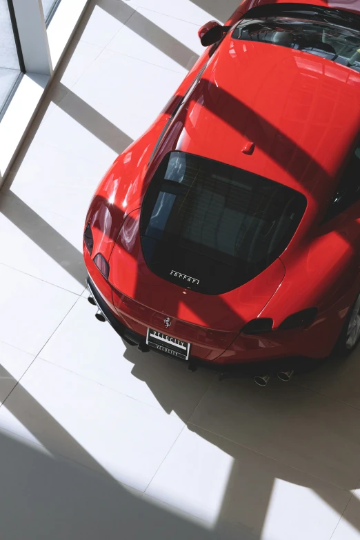 the roof of the red sports car is folded over