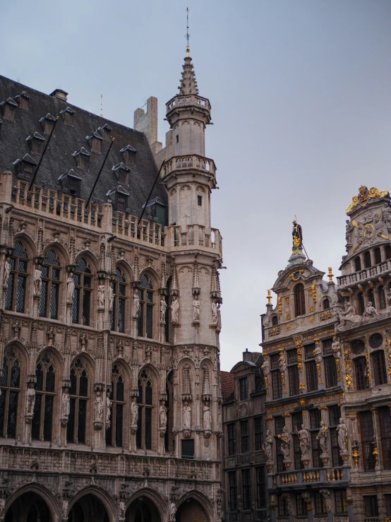 a stone building has ornate architecture and is situated against the sky