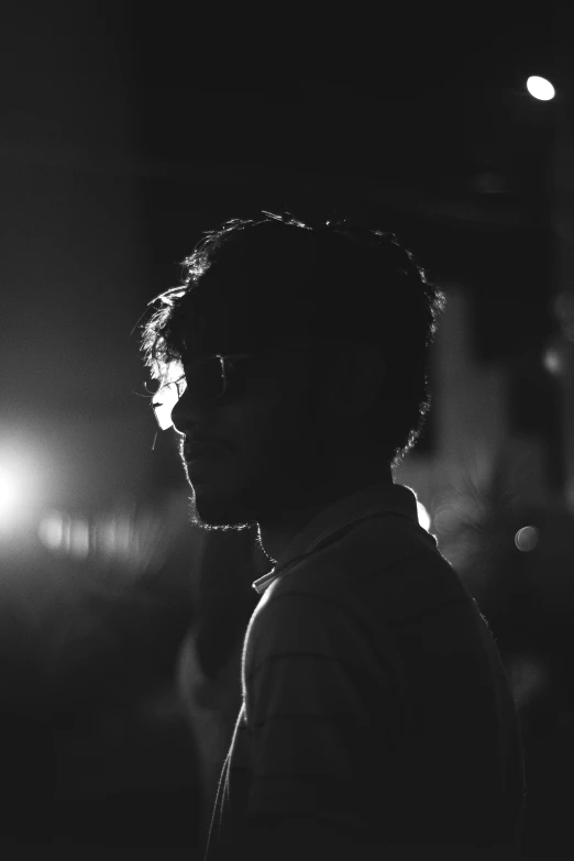 a man looking away from the camera during the night