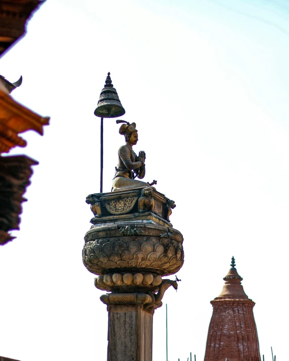 a statue of an indian with his back turned, outside