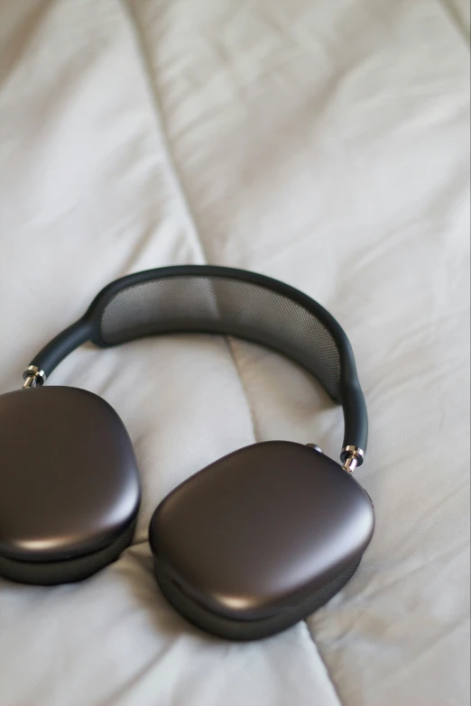 close up view of two headphones lying on a bed