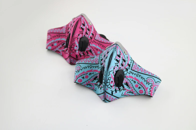 a close up of a  that has pink, black and turquoise designs on it