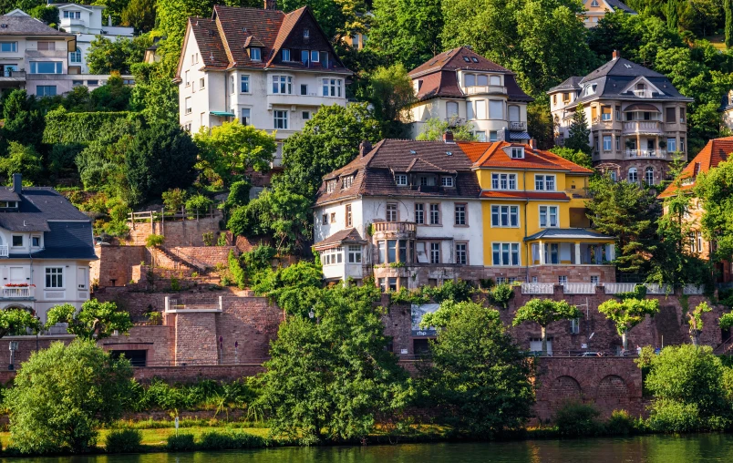 colorful houses nestled on a hillside on a river