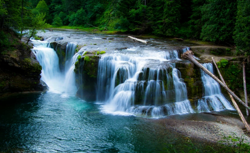 the blue water in a beautiful waterfall is running