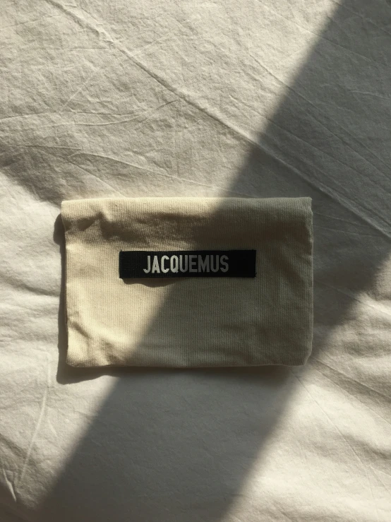 the name tag is attached to a white bed