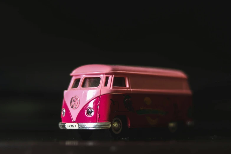 a red van parked on a black surface