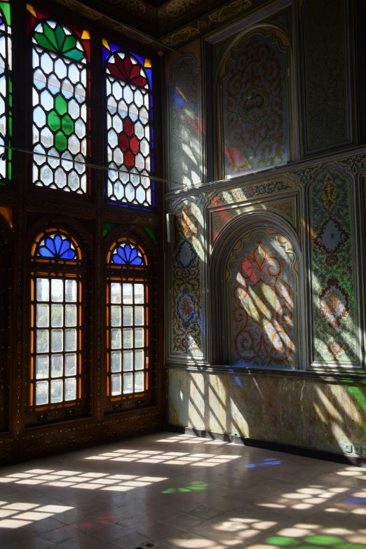 sunlight through colorful glass in a room with large windows