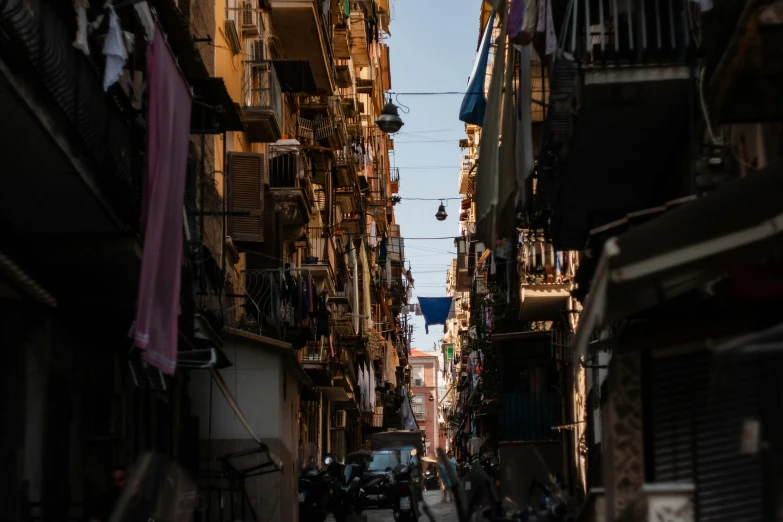 a narrow street that leads up to an apartment building with many apartments