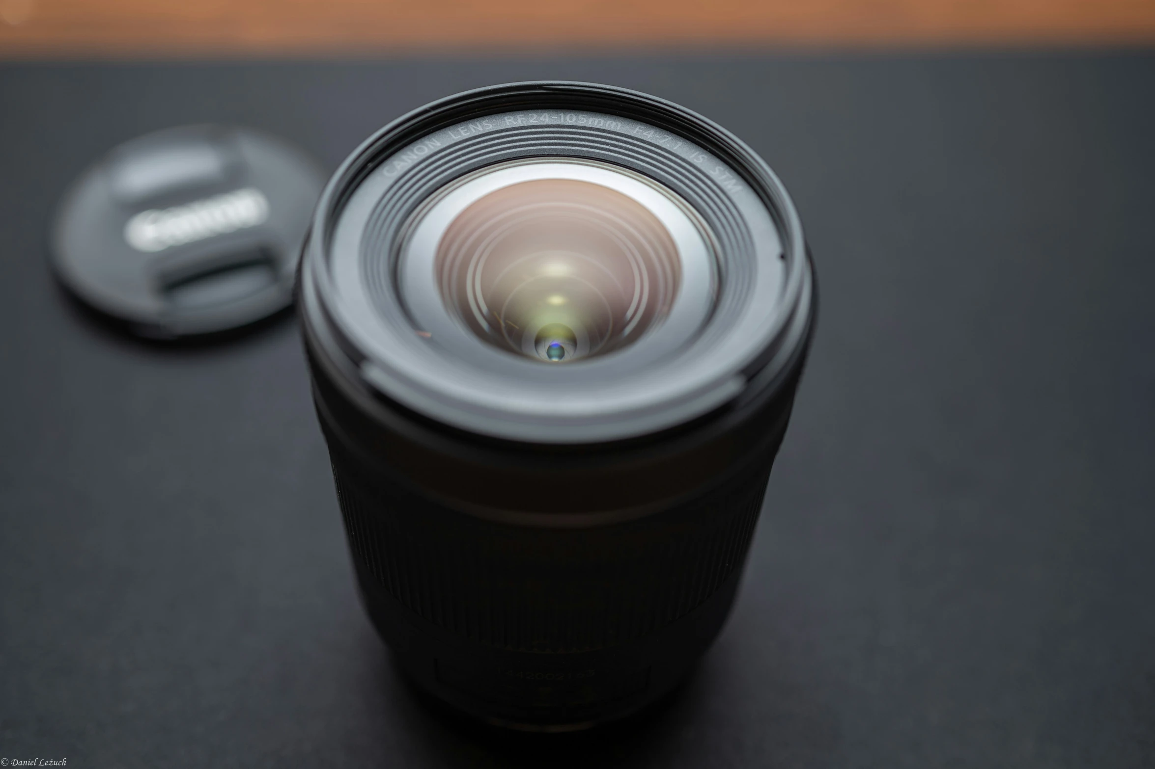 closeup of camera lens on black surface with other equipment