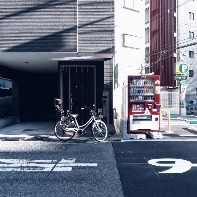 the bike is parked near the large city entrance