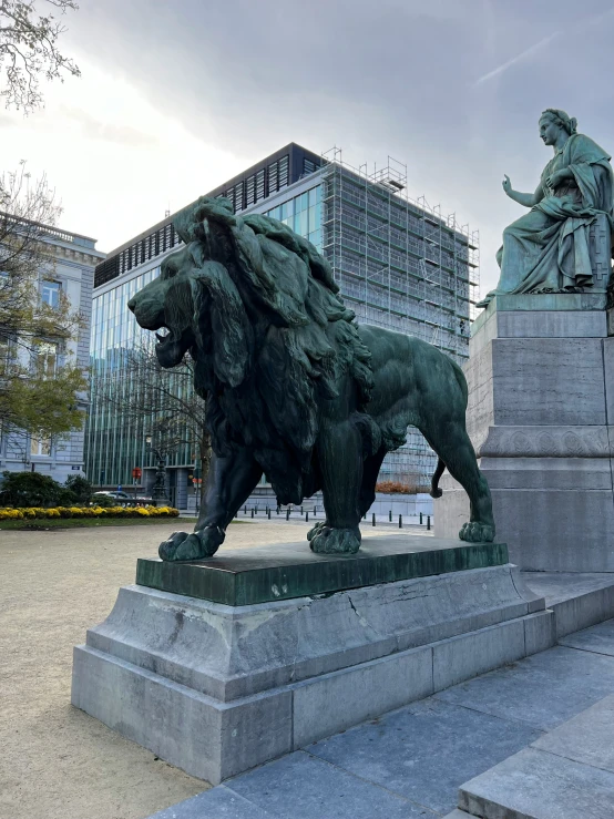 a statue of a lion next to some buildings