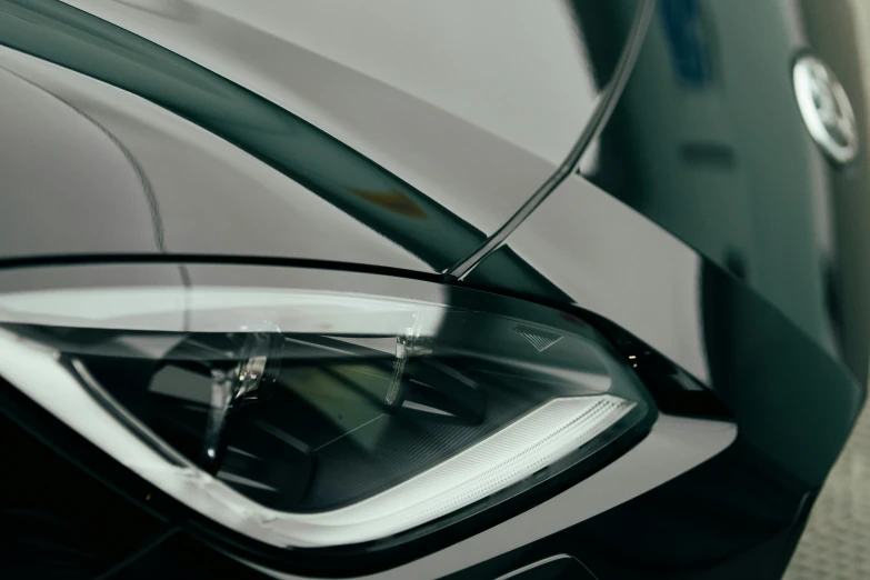 a black car headlight in front of a wall