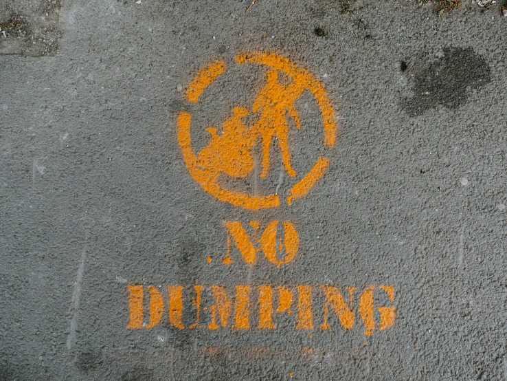 a sign that says no parking and is painted on the ground