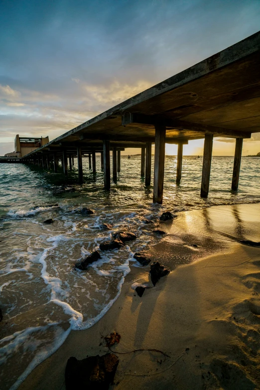 a dock in the ocean with water splashing on it