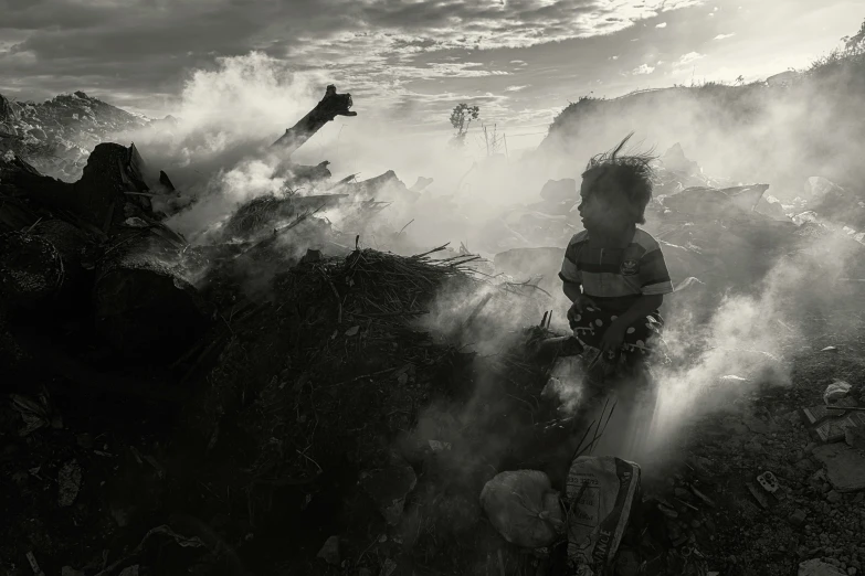 a person in striped shirt and smoke near mountains