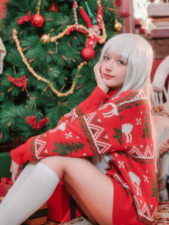 a woman sitting near a christmas tree while wearing socks