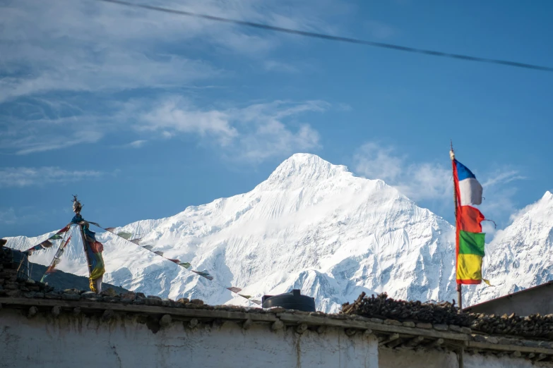 a flag on top of a building in the mountains