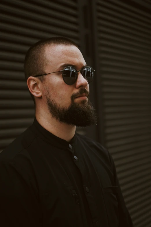 a man with glasses wearing a black shirt