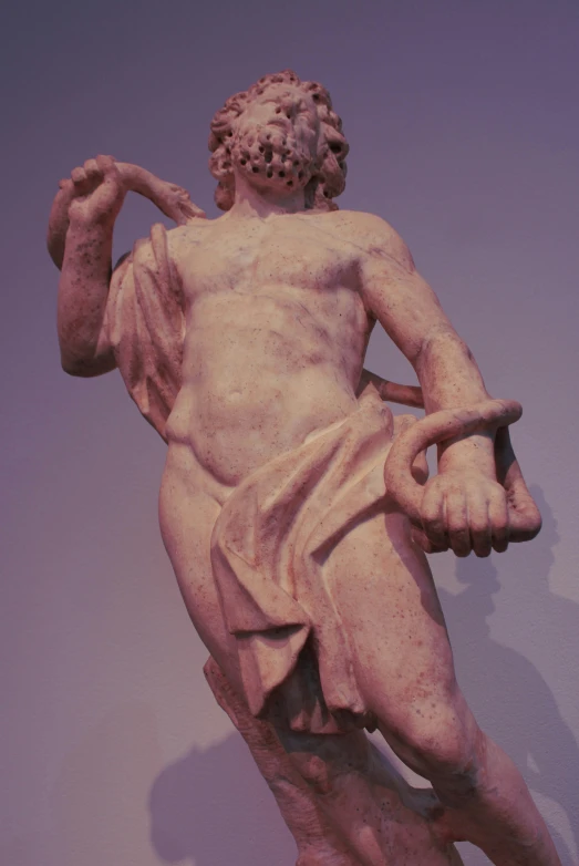 a statue of a roman figure with a staff