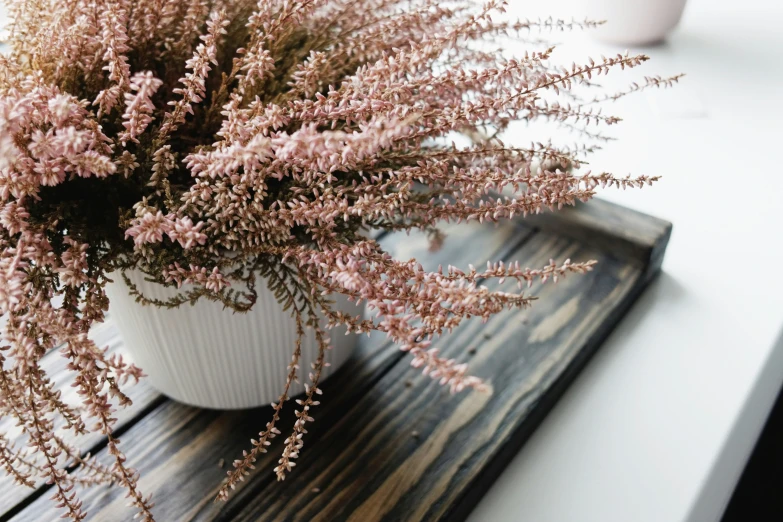 an old fashioned vase filled with flowers on a table