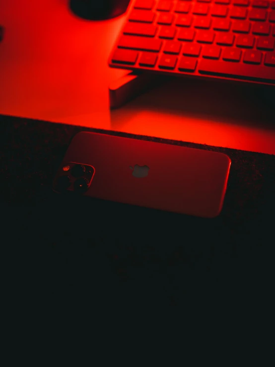 an iphone sitting in front of a computer