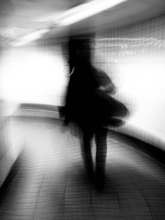 a blurry image of a person on an escalator