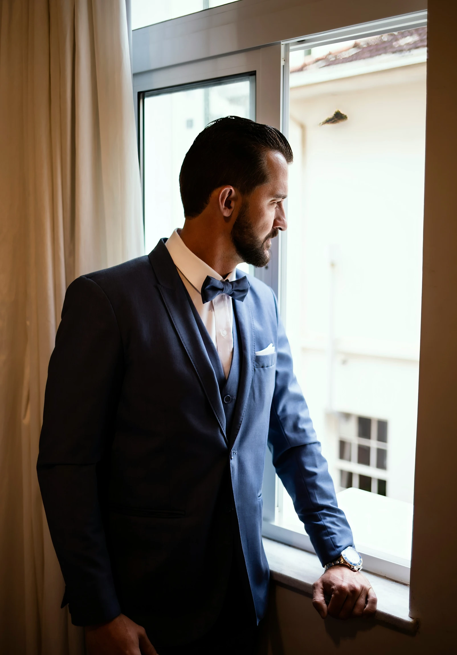 a man in a suit is staring out the window