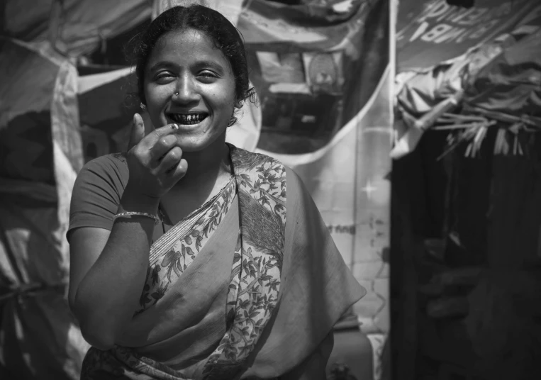 a woman is standing and making a goofy face