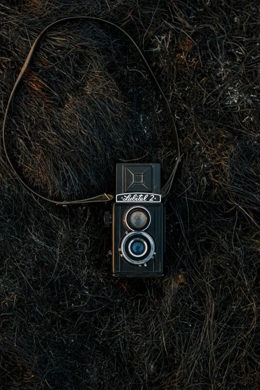 a black and white cell phone laying in grass