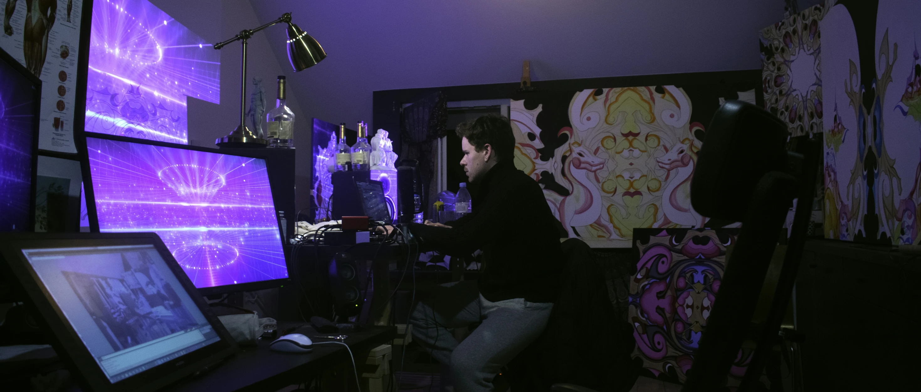 woman playing a computer game on the screen in a room with wall decor