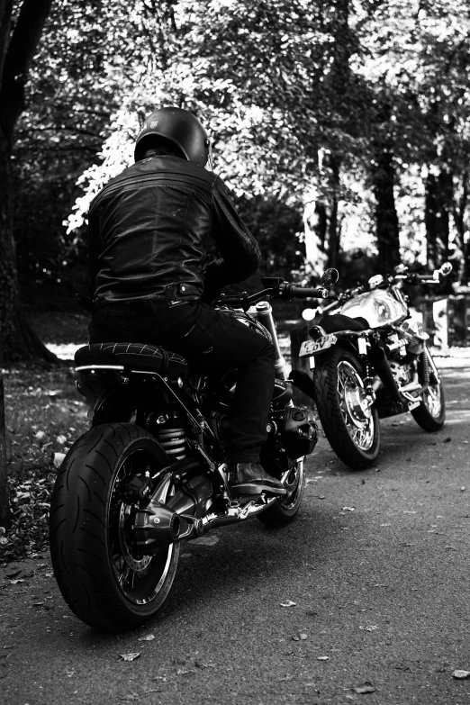 black and white po of two motorcyclists on the road