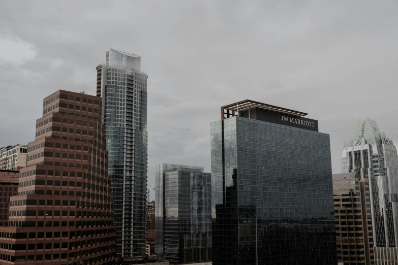 city buildings standing in the distance under cloudy skies