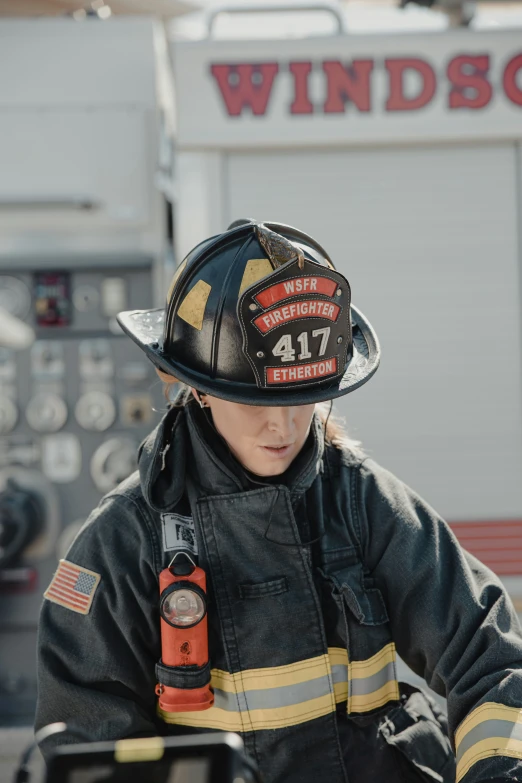 a firefighter sitting at the controls of a large fire truck