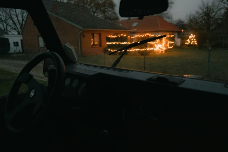 a car's steering wheel is seen through the windshield