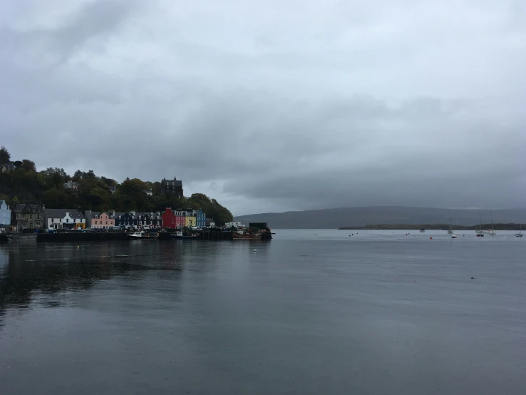 several buildings stand on land beside the water