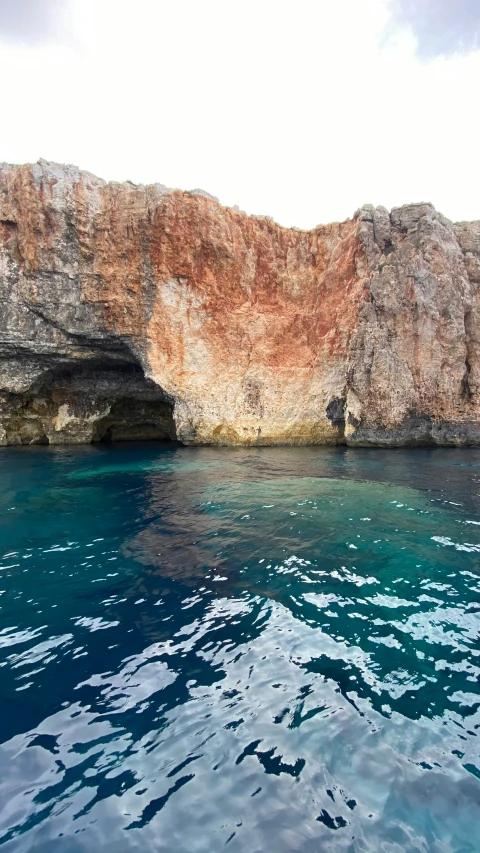 water that is blue with rock on top of it