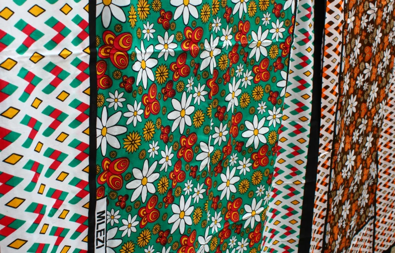 a number of wall hangings that have flowers on them