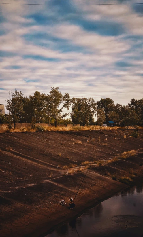 some people standing by a large field looking at soing