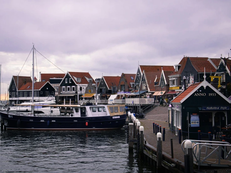 two large boats are docked along the water