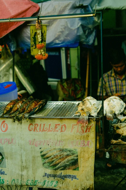 a street vendor's food stall with various kinds of grills