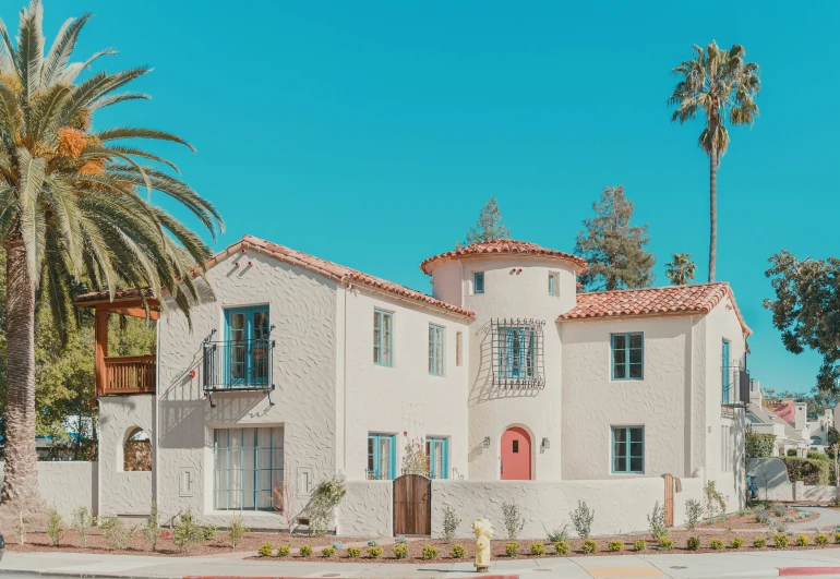 a white house with a red and blue door